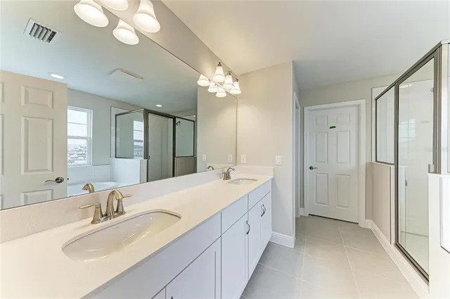 a spacious bathroom with a double vanity sink mirror and double