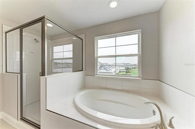 a bathroom with a bathtub and a window
