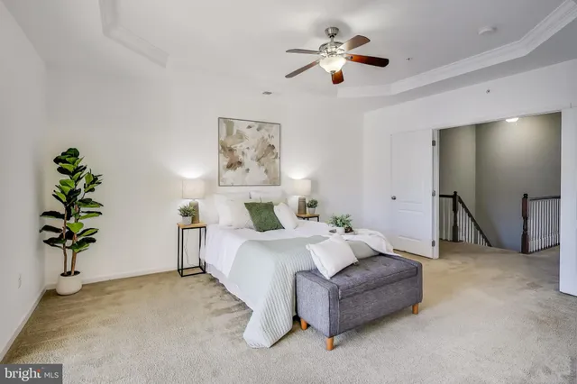 a spacious bedroom with a bed and a chandelier