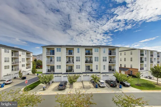 a front view of a house with outdoor seating and a tree