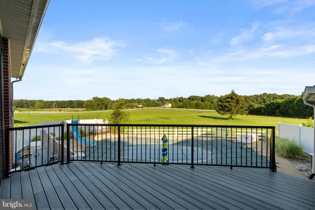 a view of wooden deck with a lake view