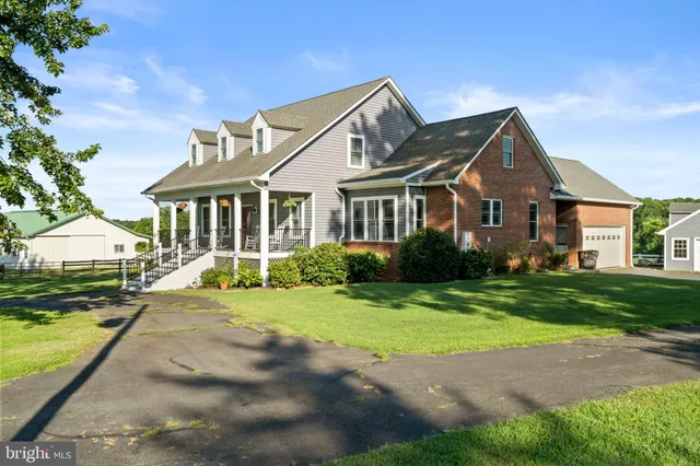 a front view of a house with a yard and porch