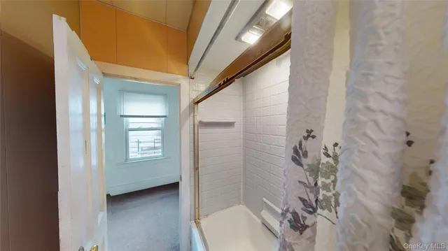 a bathroom with a tub and shower