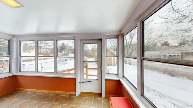 a room with pool table and windows