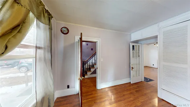 a view of an entryway with wooden floor