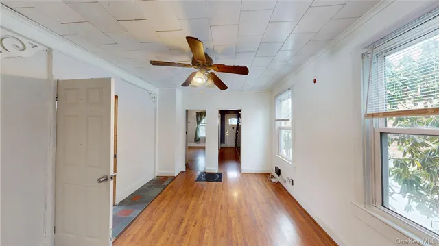 a view of hallway with wooden floor and window
