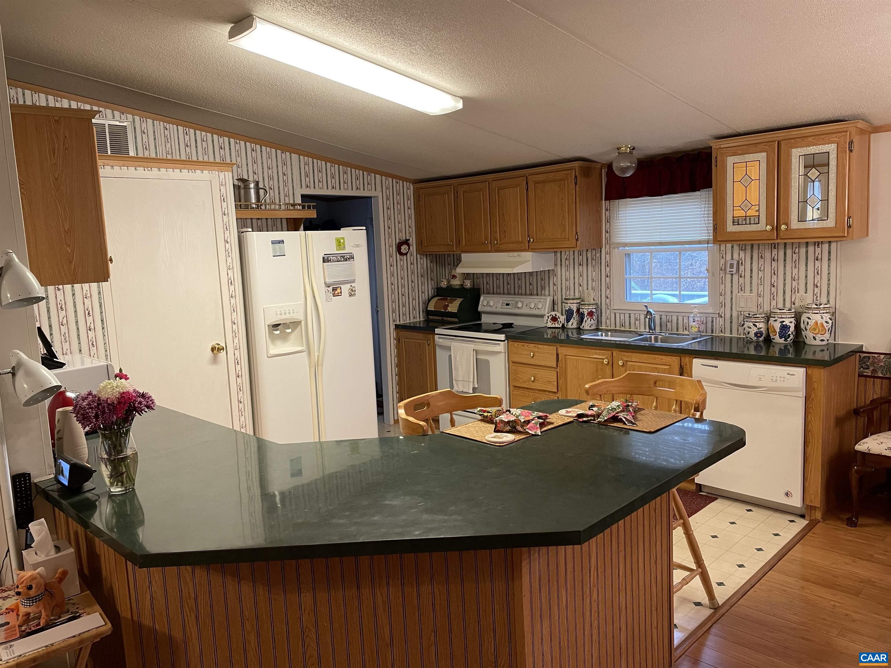 2925 Cloverdale Road Bremo Bluff, VA 23022 - Photo 7 of 23 a kitchen with stainless steel appliances granite countertop a sink refrigerator and stove
