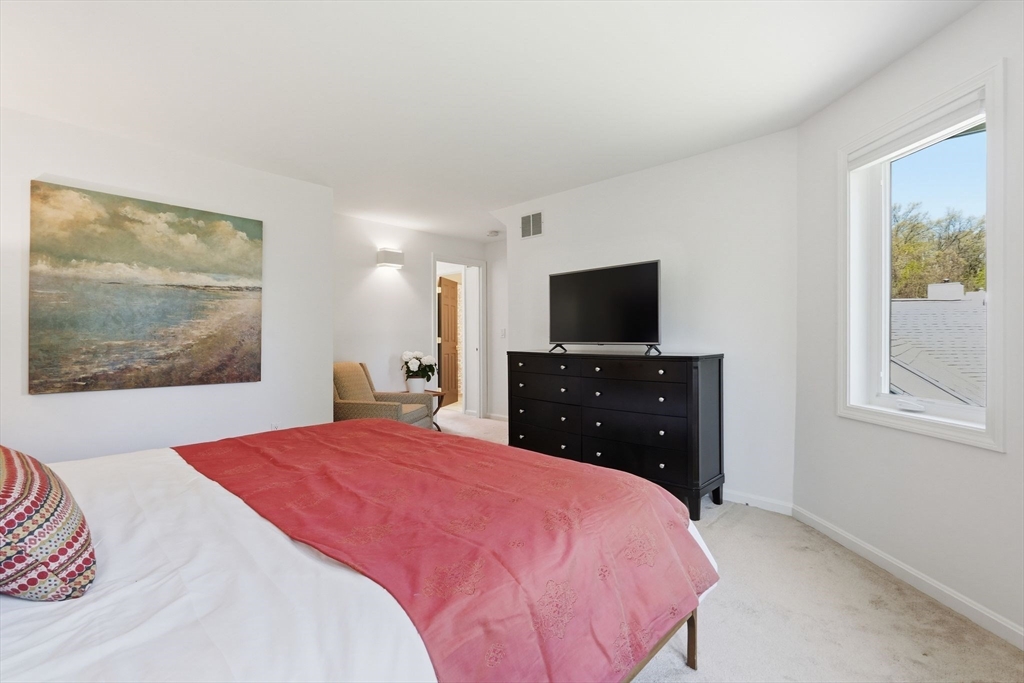 24 McIntosh Drive, Unit 24 Amherst, MA 01002 - Photo 23 of 39 a bedroom with a bed and a flat screen tv