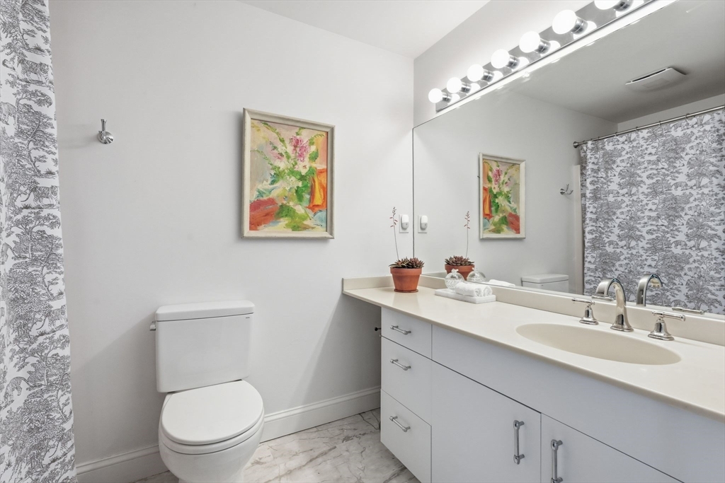 24 McIntosh Drive, Unit 24 Amherst, MA 01002 - Photo 27 of 39 a bathroom with a toilet a sink a mirror and a shower