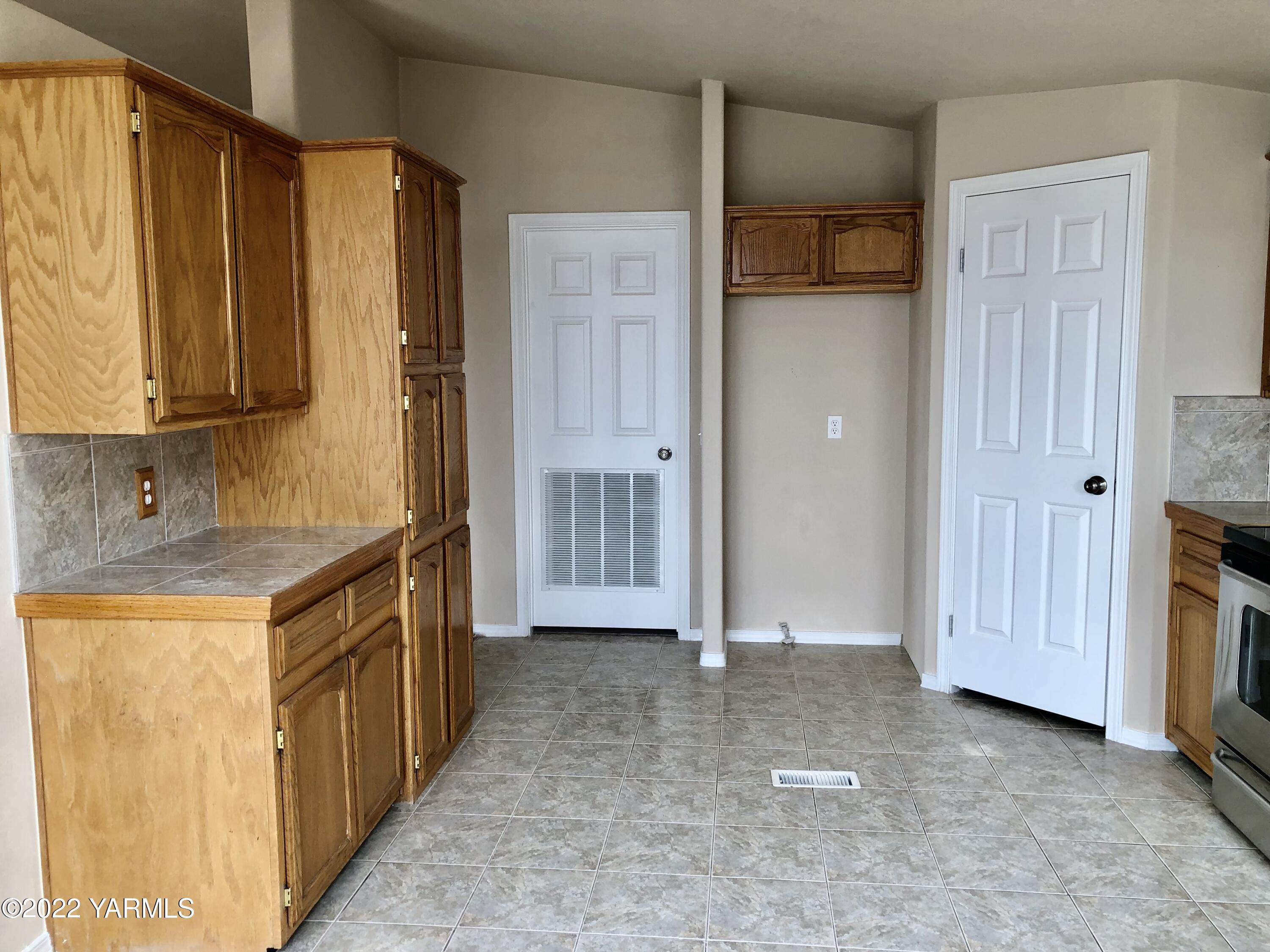 4912 Lateral A Road Wapato, WA 98951 - Photo 13 of 31 a bathroom with a granite countertop sink and a mirror