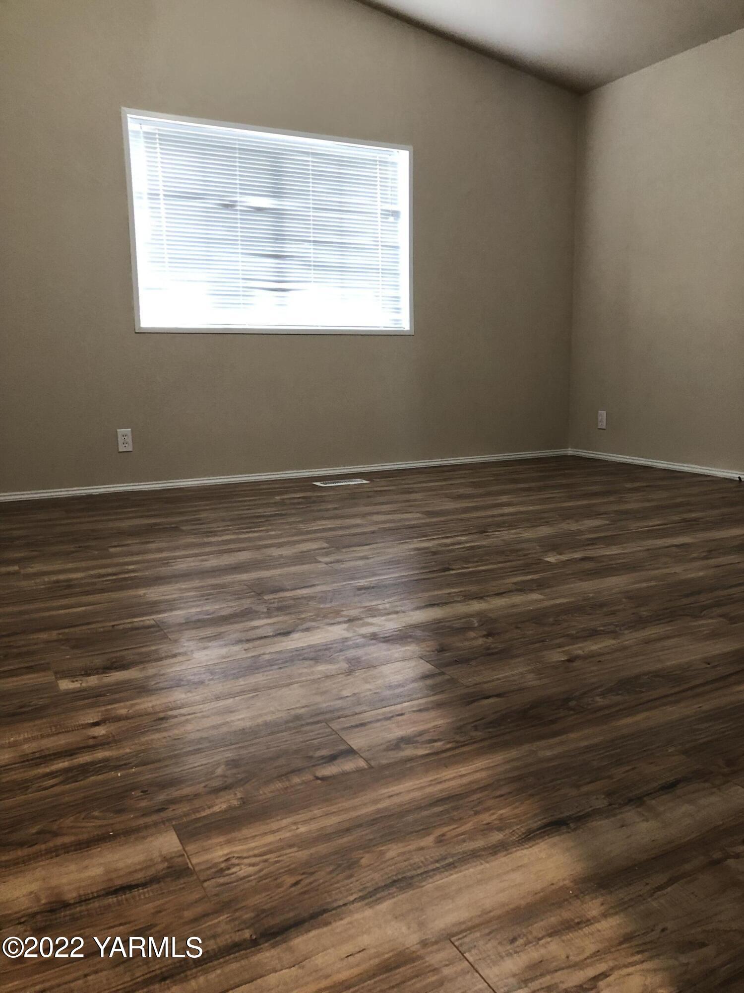 4912 Lateral A Road Wapato, WA 98951 - Photo 21 of 31 a view of an empty room with wooden floor and a window