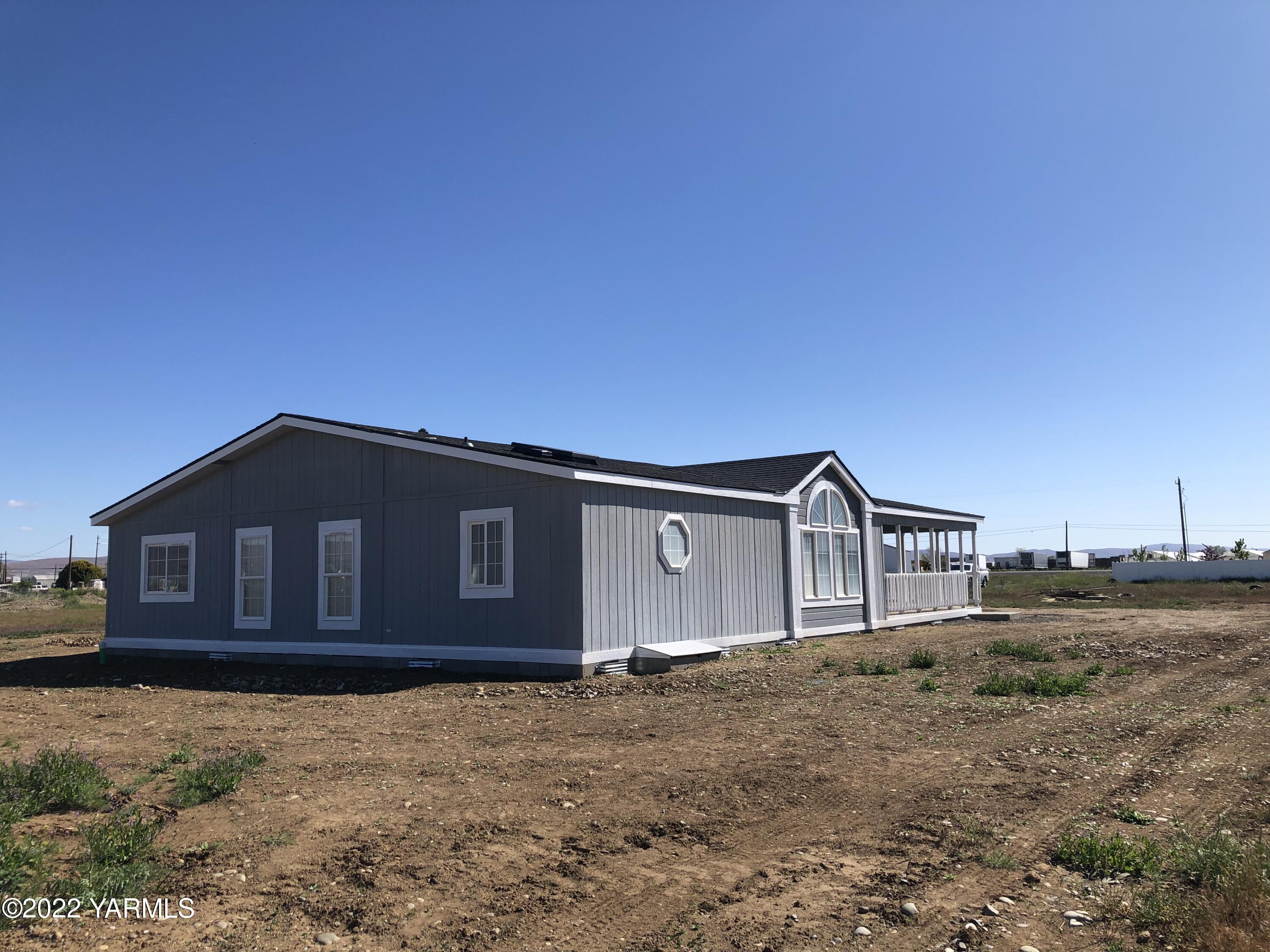 4912 Lateral A Road Wapato, WA 98951 - Photo 30 of 31 a front view of a house with a yard