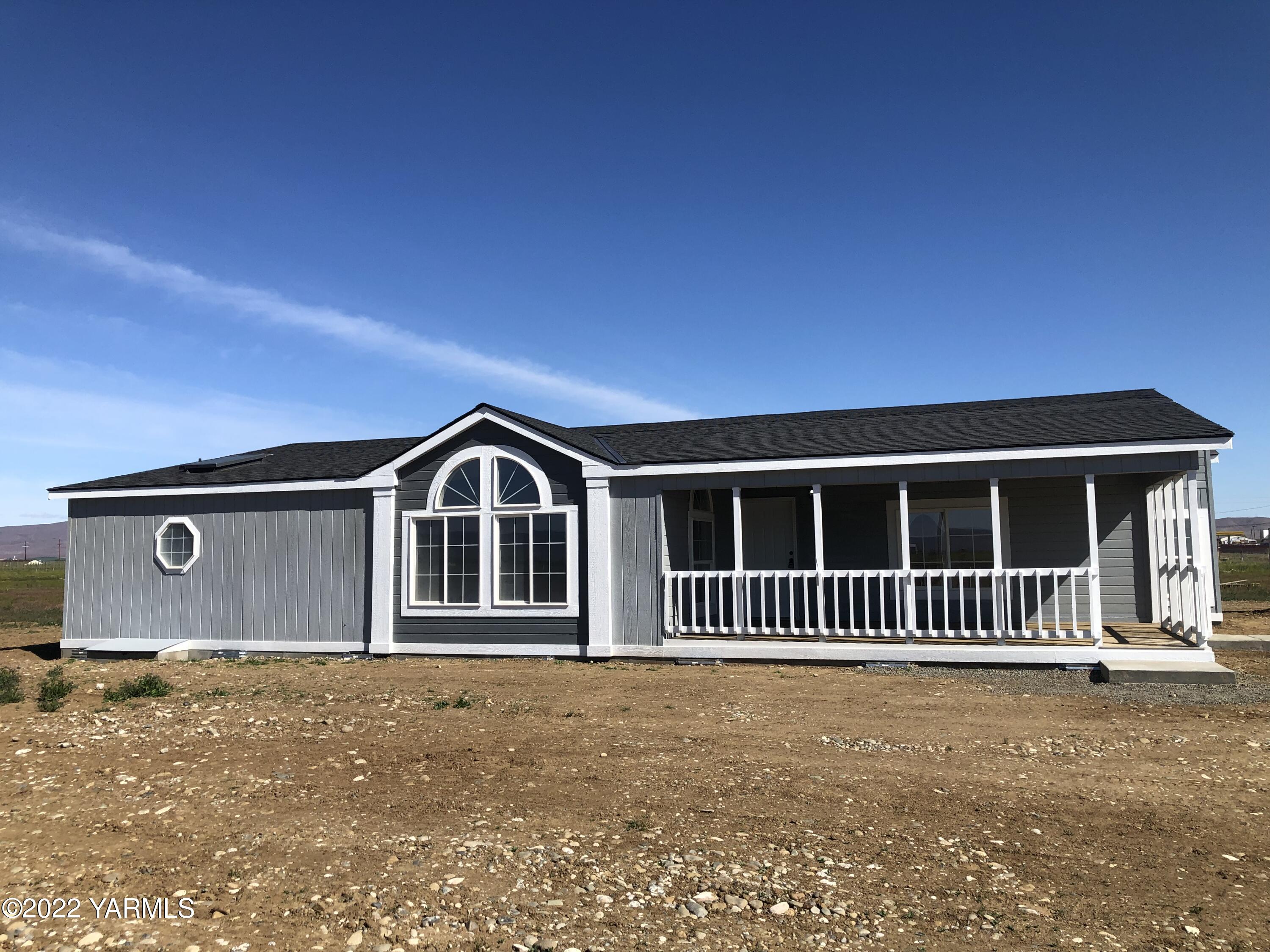 4912 Lateral A Road Wapato, WA 98951 - Photo 3 of 31 a front view of a house with a garden