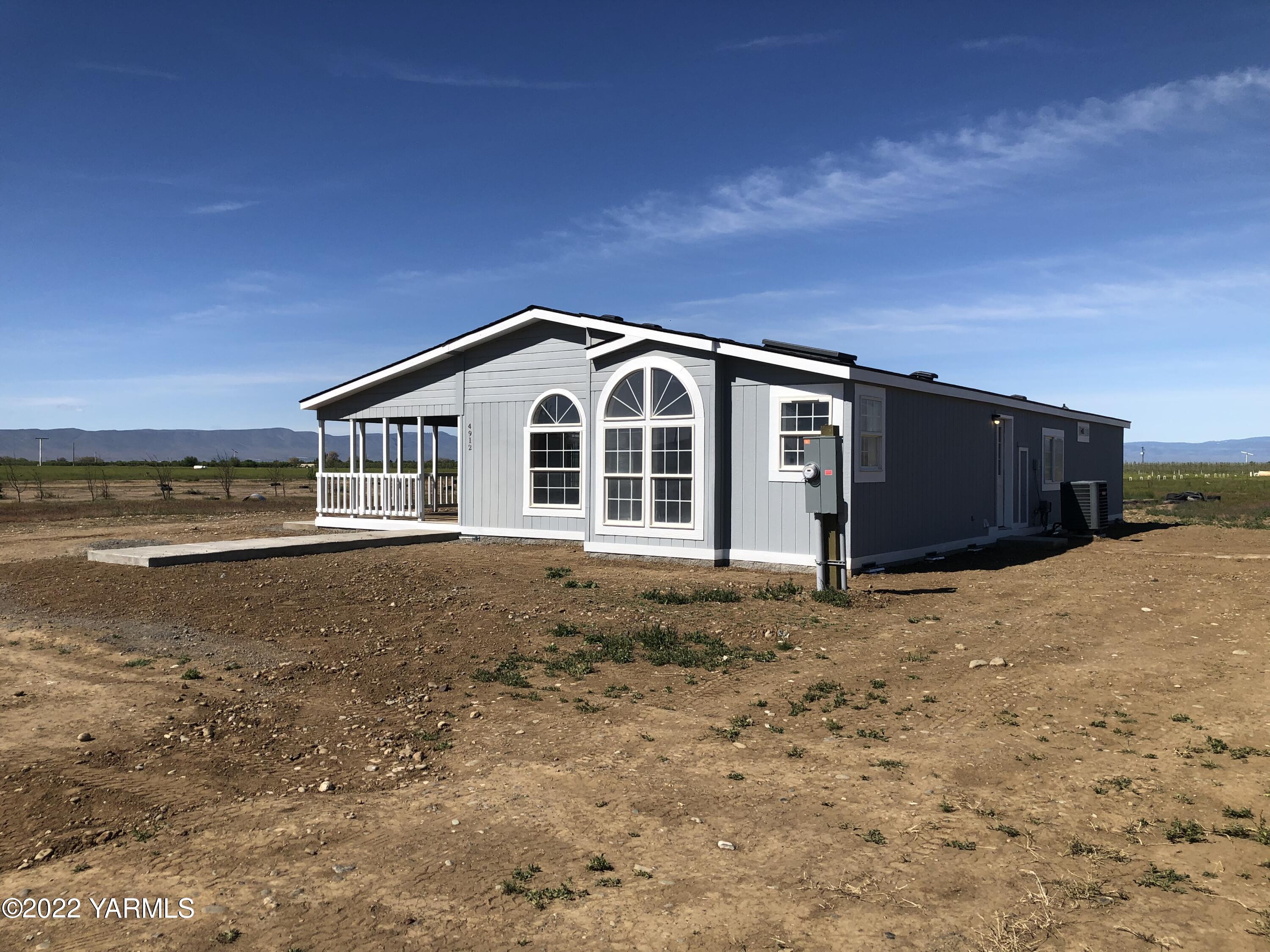 4912 Lateral A Road Wapato, WA 98951 - Photo 31 of 31 a front view of a house with a yard