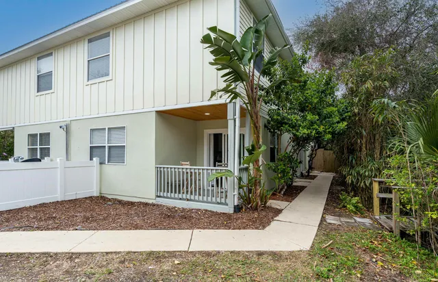 a view of a house with a yard and plants
