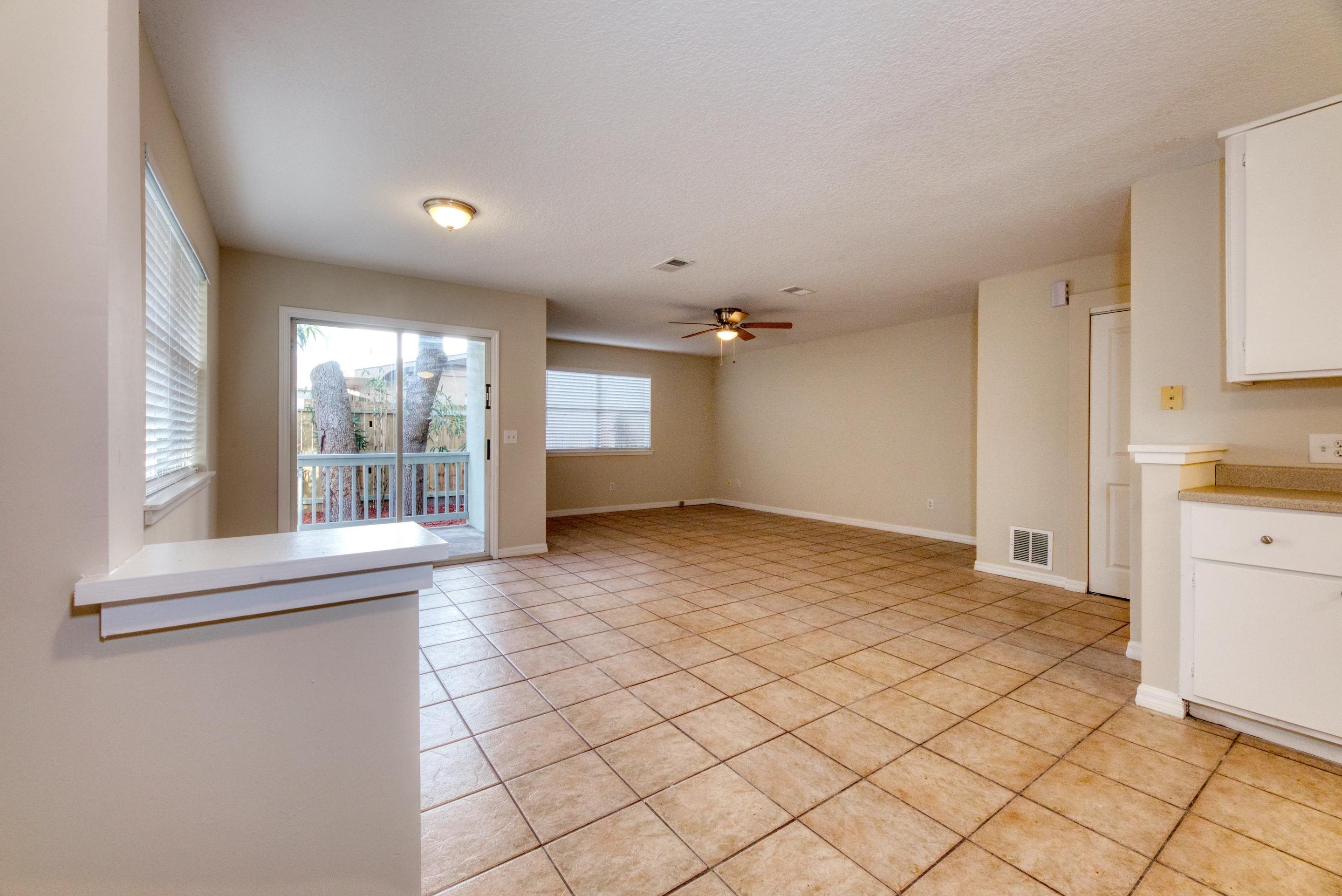 203 E Street St. Augustine, FL 32080 - Photo 29 of 68 Unfurnished living room featuring light tile patterned floors, a ceiling fan, and a textured ceiling