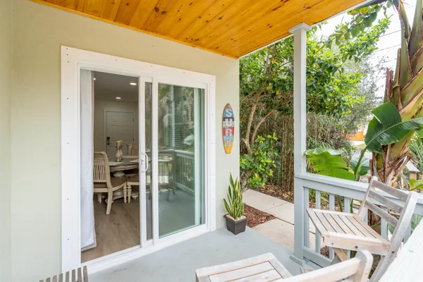 a view of porch with a bench and floor to ceiling window