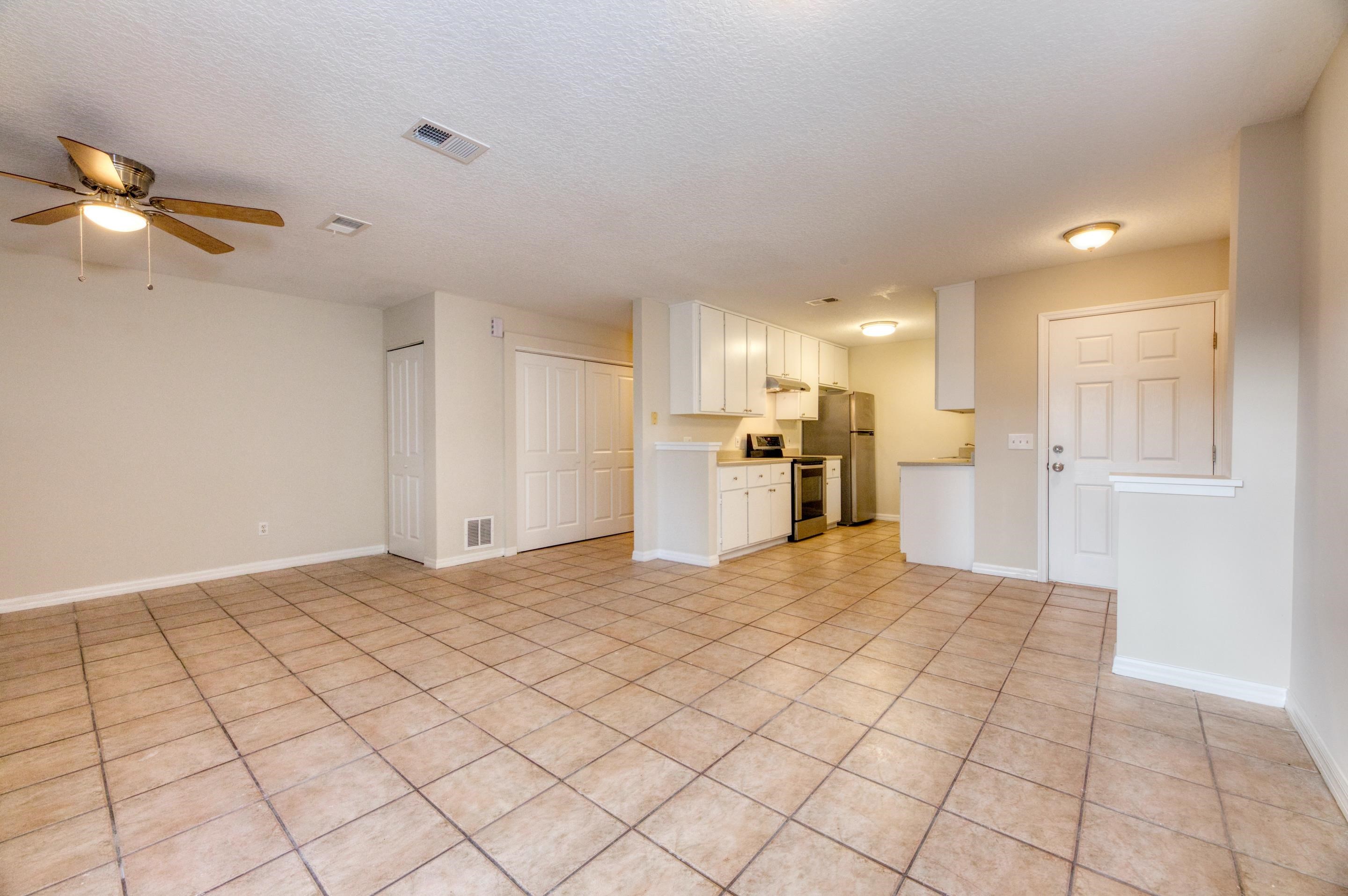 203 E Street St. Augustine, FL 32080 - Photo 30 of 68 Unfurnished living room featuring a textured ceiling, light tile patterned flooring, and ceiling fan