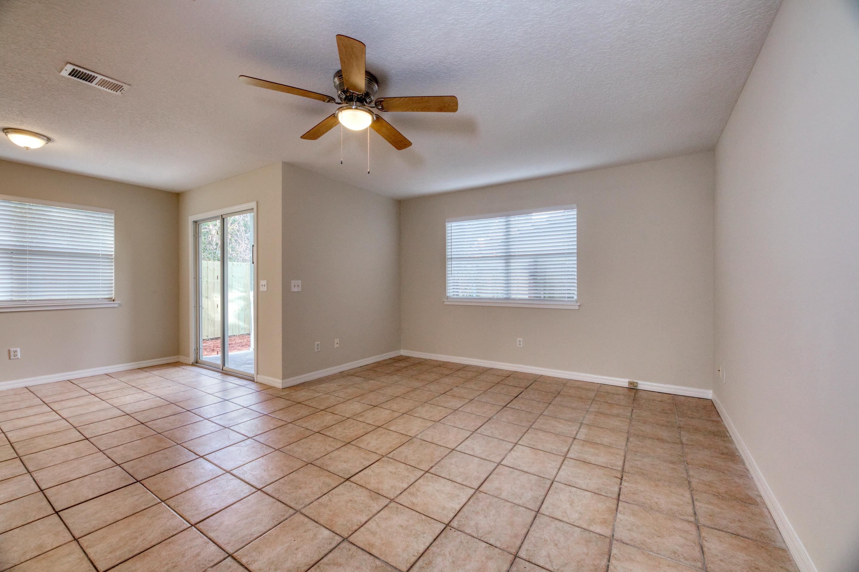 203 E Street St. Augustine, FL 32080 - Photo 33 of 68 Empty room with ceiling fan, a textured ceiling, and light tile patterned flooring