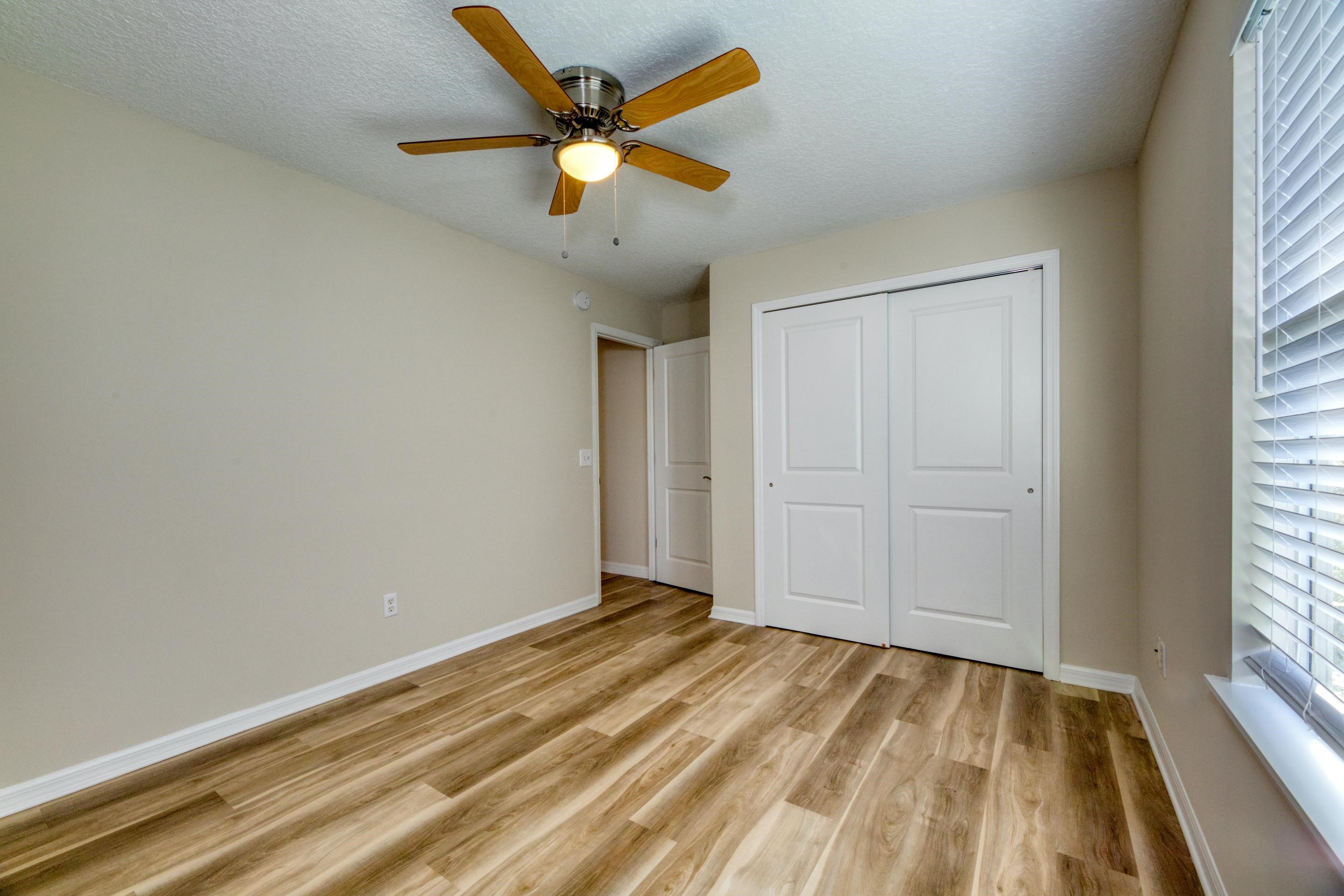 203 E Street St. Augustine, FL 32080 - Photo 43 of 68 Unfurnished bedroom featuring light wood-type flooring, a ceiling fan, a closet, and a textured ceiling