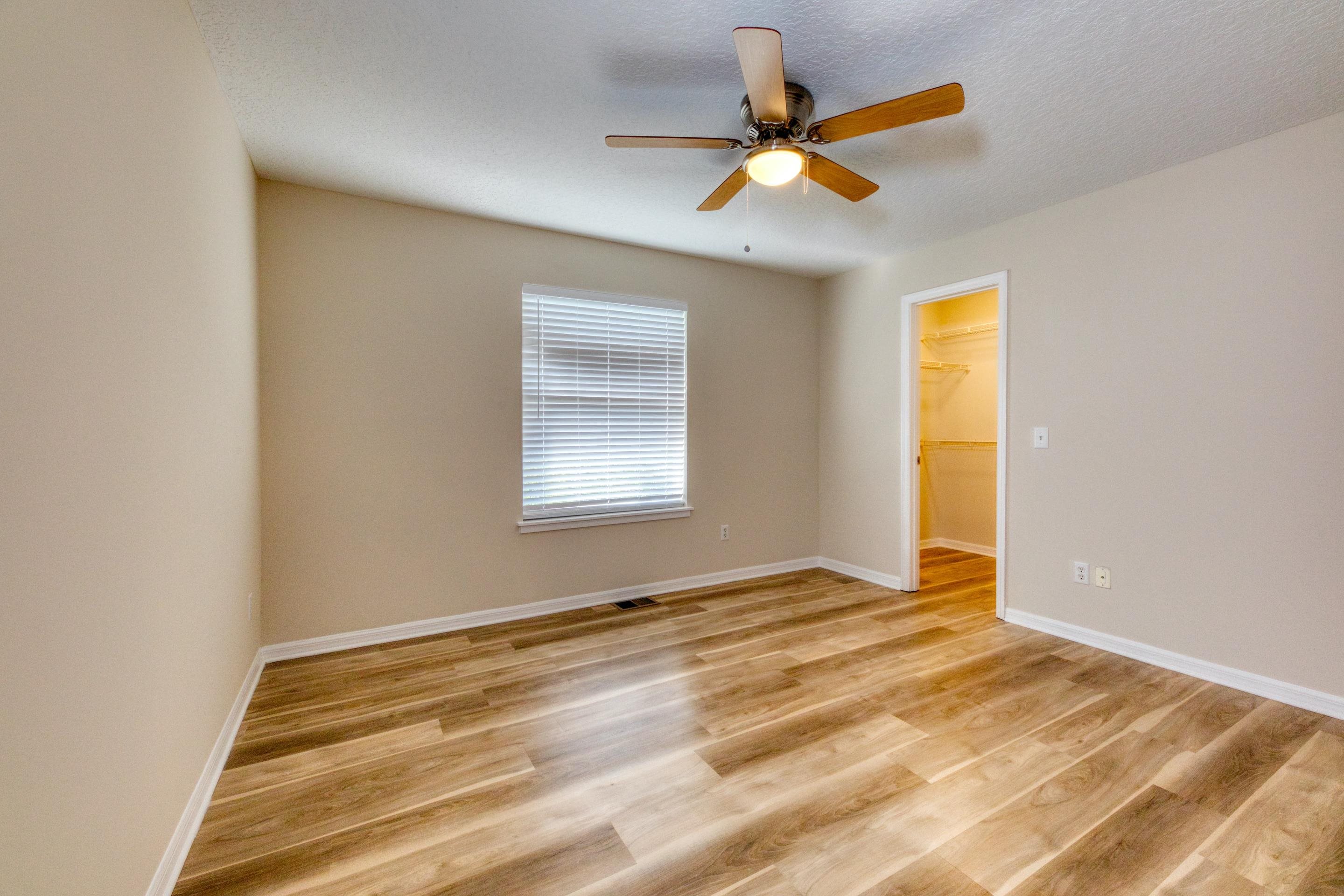 203 E Street St. Augustine, FL 32080 - Photo 45 of 68 Unfurnished bedroom featuring ceiling fan, light wood-style flooring, a spacious closet, and a textured ceiling