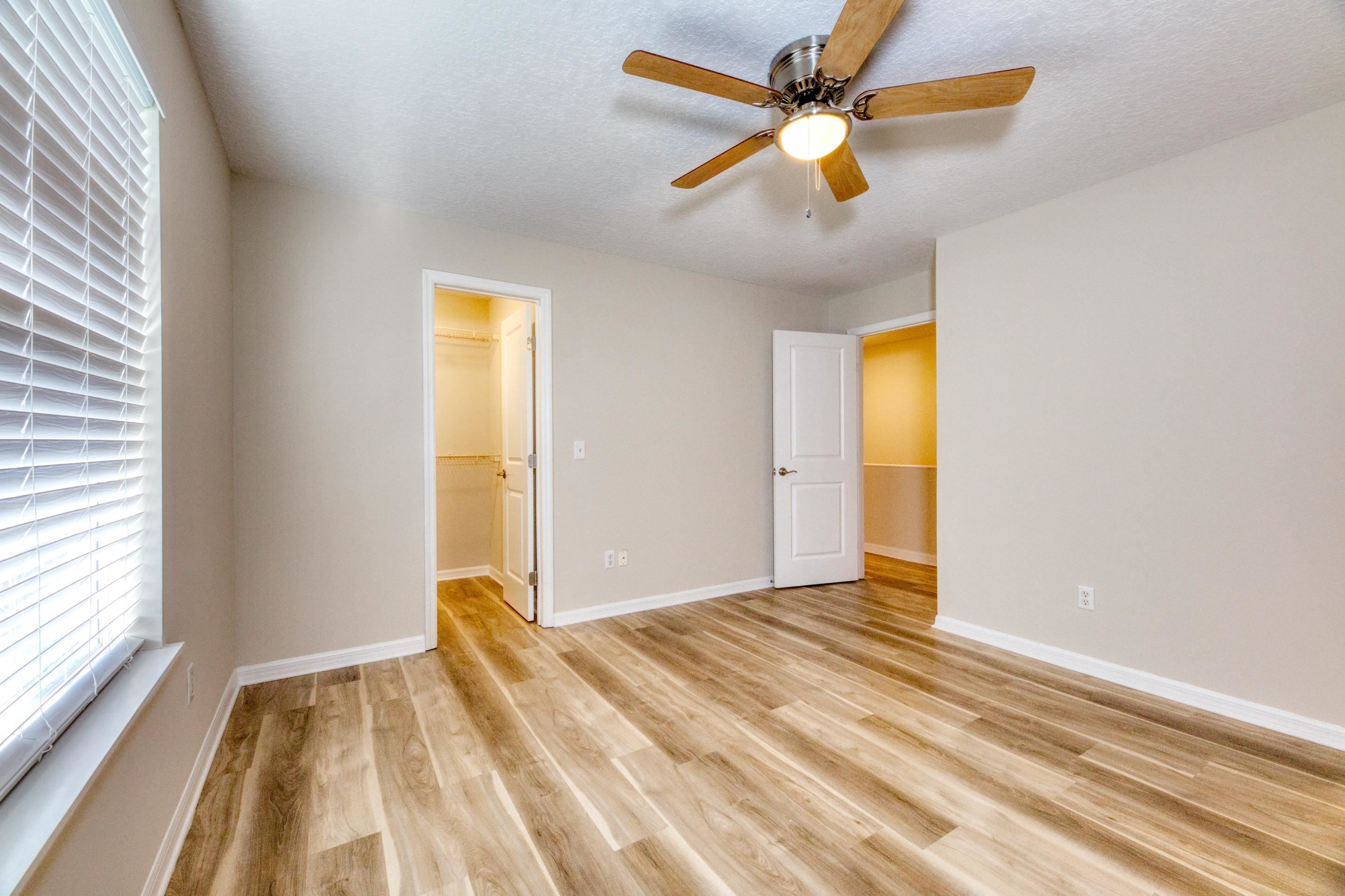 203 E Street St. Augustine, FL 32080 - Photo 46 of 68 Unfurnished bedroom with light wood-style floors, a spacious closet, ceiling fan, and a textured ceiling