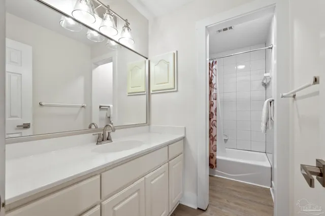 a bathroom with a shower sink and mirror