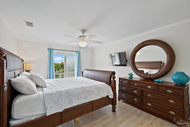 a bedroom with a bed and a mirror on dresser