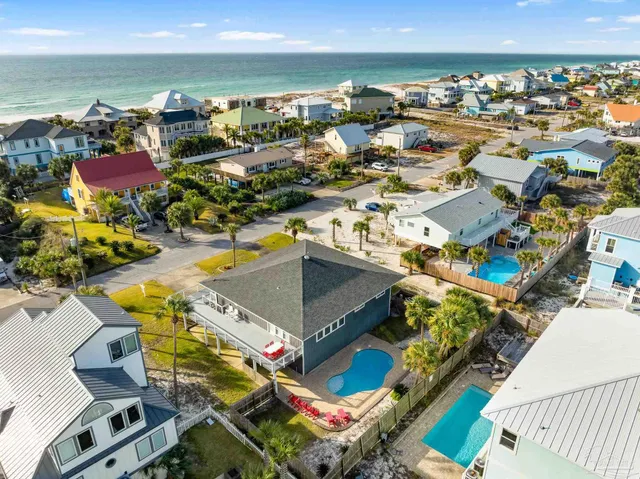 an aerial view of residential houses with outdoor space