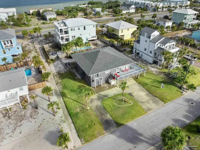 an aerial view of residential houses with outdoor space