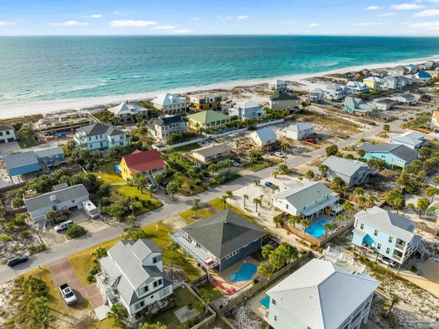 an aerial view of multiple houses with yard