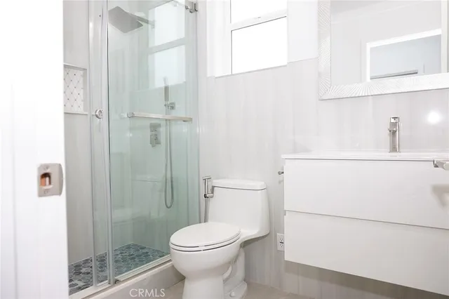 a bathroom with a toilet a sink and shower