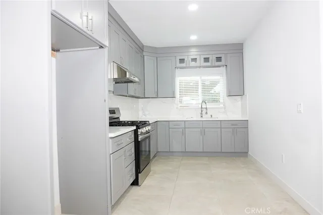 a kitchen with a sink cabinets and stainless steel appliances