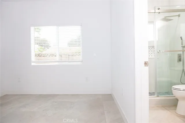 a bathroom with a toilet a sink and a shower