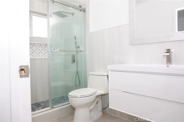 a bathroom with a toilet sink and shower