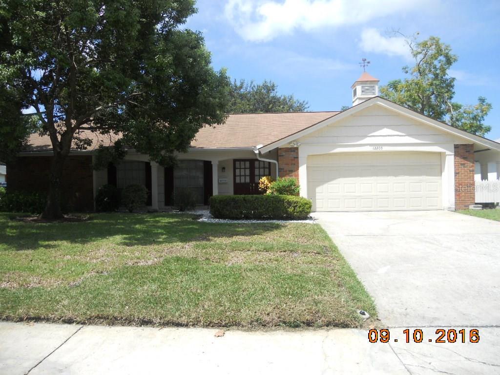 12205 Quail Run Row Hudson, FL 34667 - Photo 1 of 1 a view of a white house with a yard