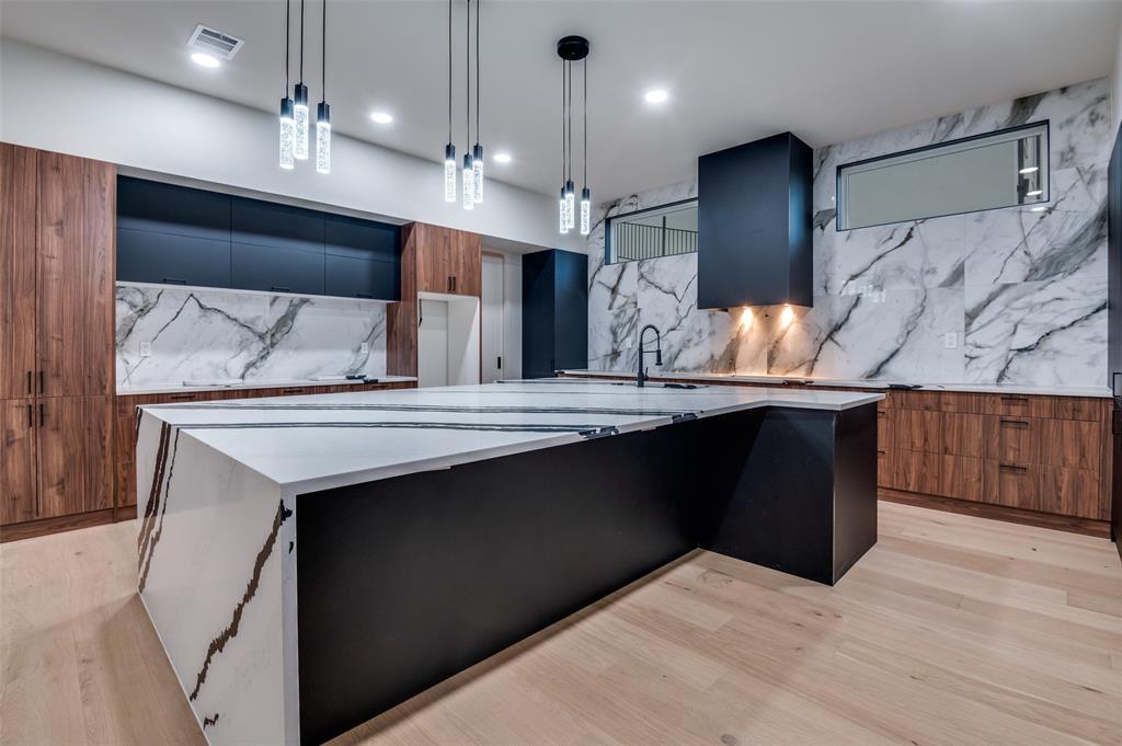 6301 Tiffany Oaks Lane Arlington, TX 76016 - Photo 15 of 40 a kitchen with kitchen island a sink stainless steel appliances and cabinets
