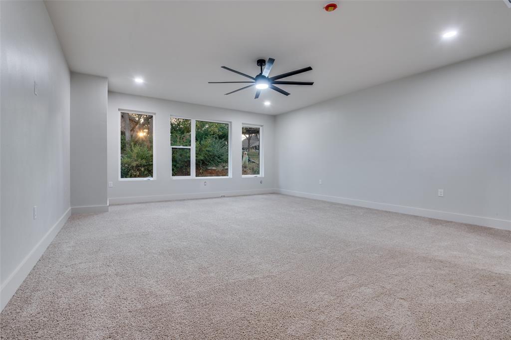 6301 Tiffany Oaks Lane Arlington, TX 76016 - Photo 18 of 40 an empty room with windows and ceiling fan