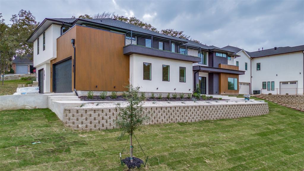 6301 Tiffany Oaks Lane Arlington, TX 76016 - Photo 2 of 40 a front view of a house with a garden and plants