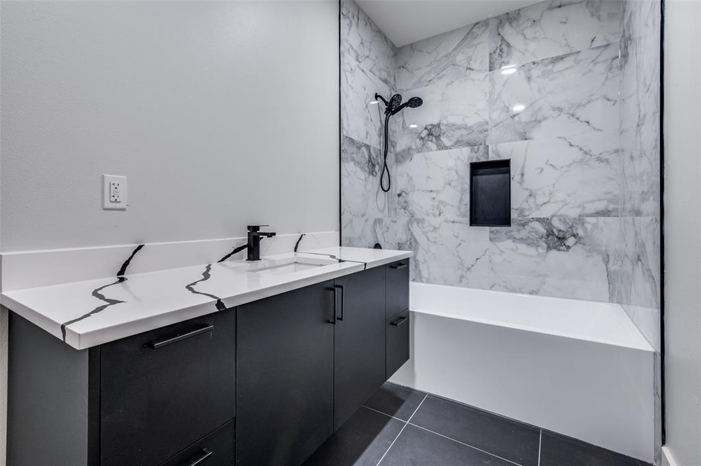 6301 Tiffany Oaks Lane Arlington, TX 76016 - Photo 30 of 40 a bathroom with a sink double vanity granite tub shower and a mirror