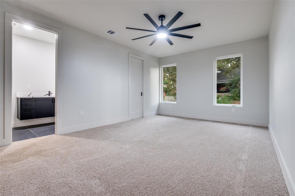 6301 Tiffany Oaks Lane Arlington, TX 76016 - Photo 31 of 40 an empty room with a window and a ceiling fan
