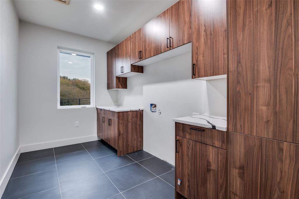 6301 Tiffany Oaks Lane Arlington, TX 76016 - Photo 35 of 40 a kitchen with stainless steel appliances granite countertop a sink a stove and a refrigerator