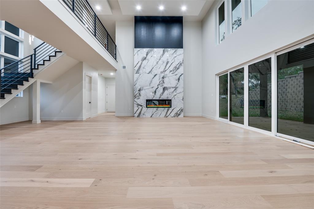 6301 Tiffany Oaks Lane Arlington, TX 76016 - Photo 10 of 40 a view of an empty room with wooden floor and windows