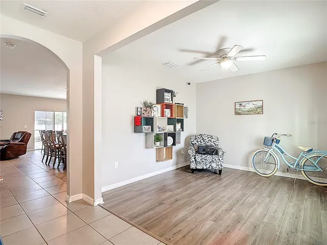 a kitchen with stainless steel appliances granite countertop a stove top oven a sink dishwasher a dining table and chairs with wooden floor