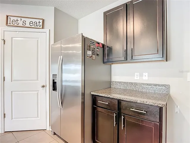 a living room with furniture a flat screen tv and a window