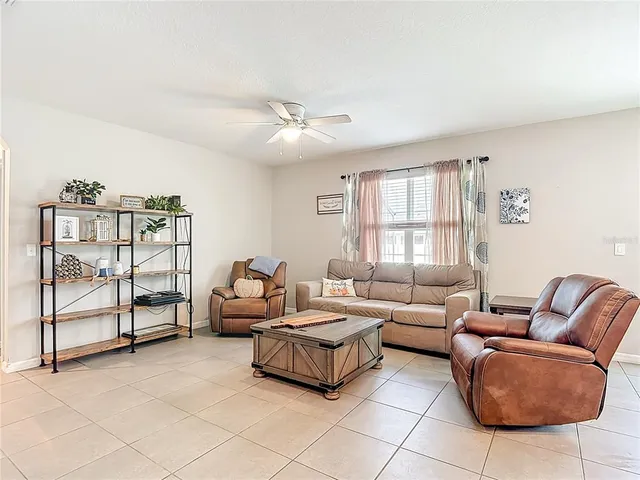 a living room with furniture and stairs