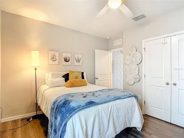 a bedroom with a bed and a flat screen tv