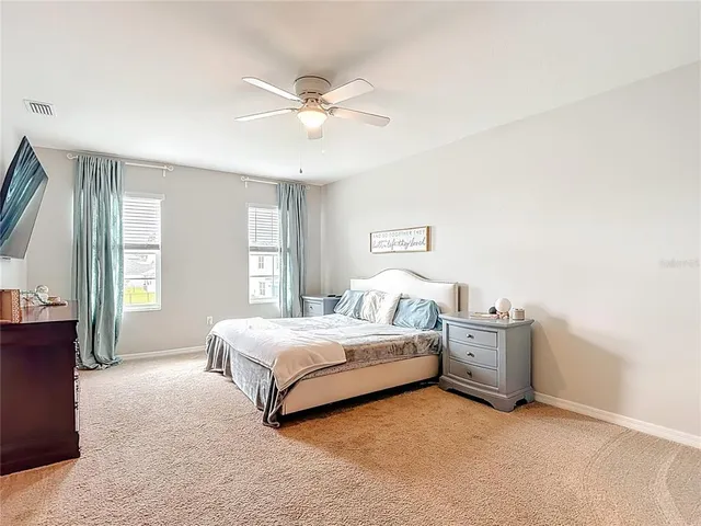 an empty room with a window and a fan