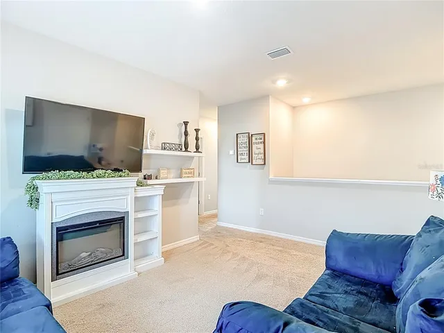 a view of a house with a backyard and a patio