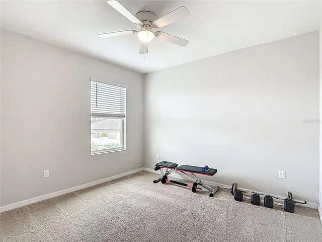 an aerial view of a house with a big yard and large trees